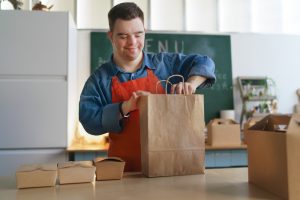 Cheerful,Young,Down,Syndrome,Waiter,Working,In,Take,Away,Restaurant,