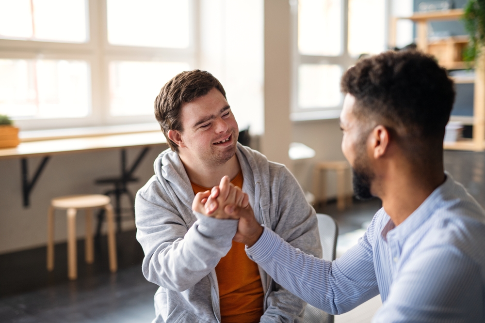 Young,Happy,Man,With,Down,Syndrome,With,His,Mentoring,Friend