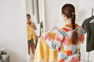 Back,View,At,Teenage,Girl,With,Down,Syndrome,Choosing,Clothes