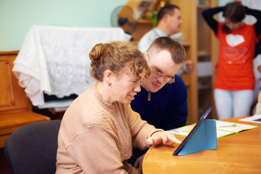 Two,Friends,With,Disability,In,Rehabilitation,Center,,Watching,Digital,Tablet